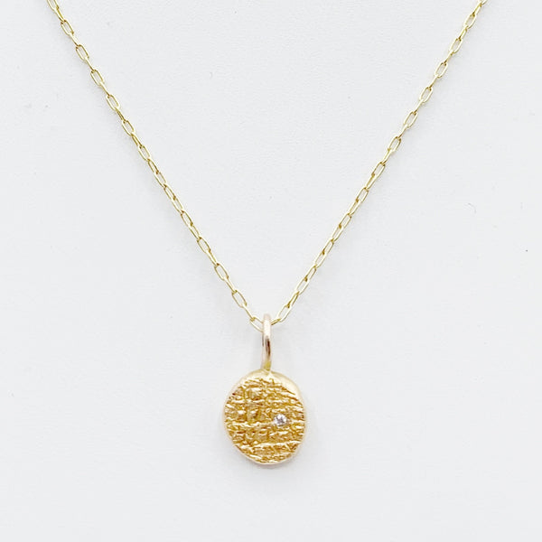Diamond Embedded in a Textured Coin Shape