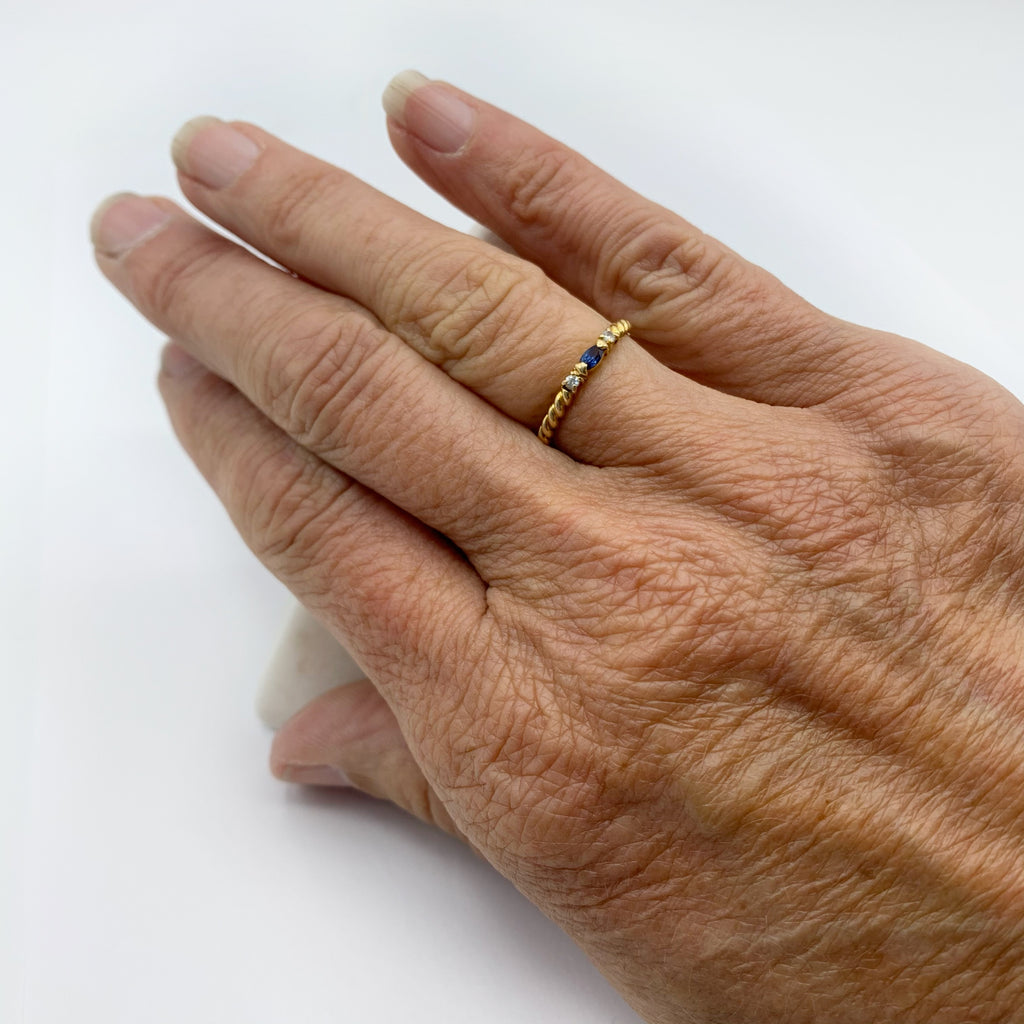 Spiraled Golden Ring with Diamonds and a Sapphire